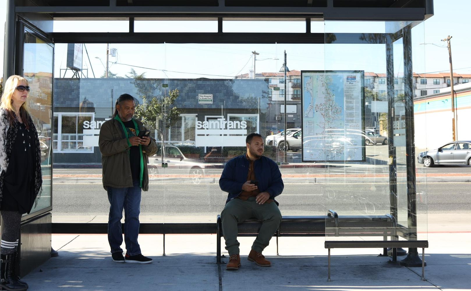 people waiting at a bus stop