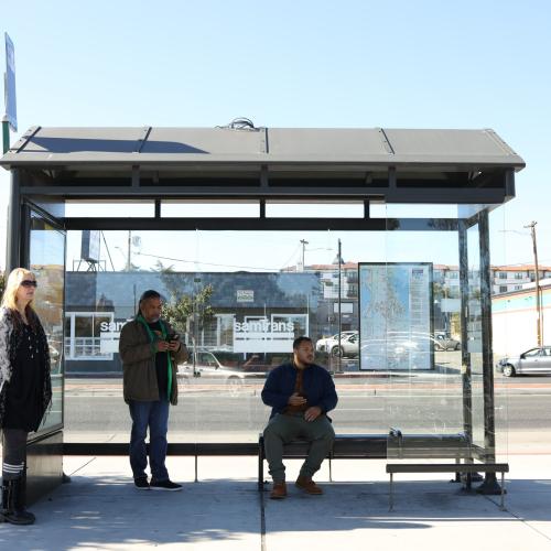 people waiting at a bus stop