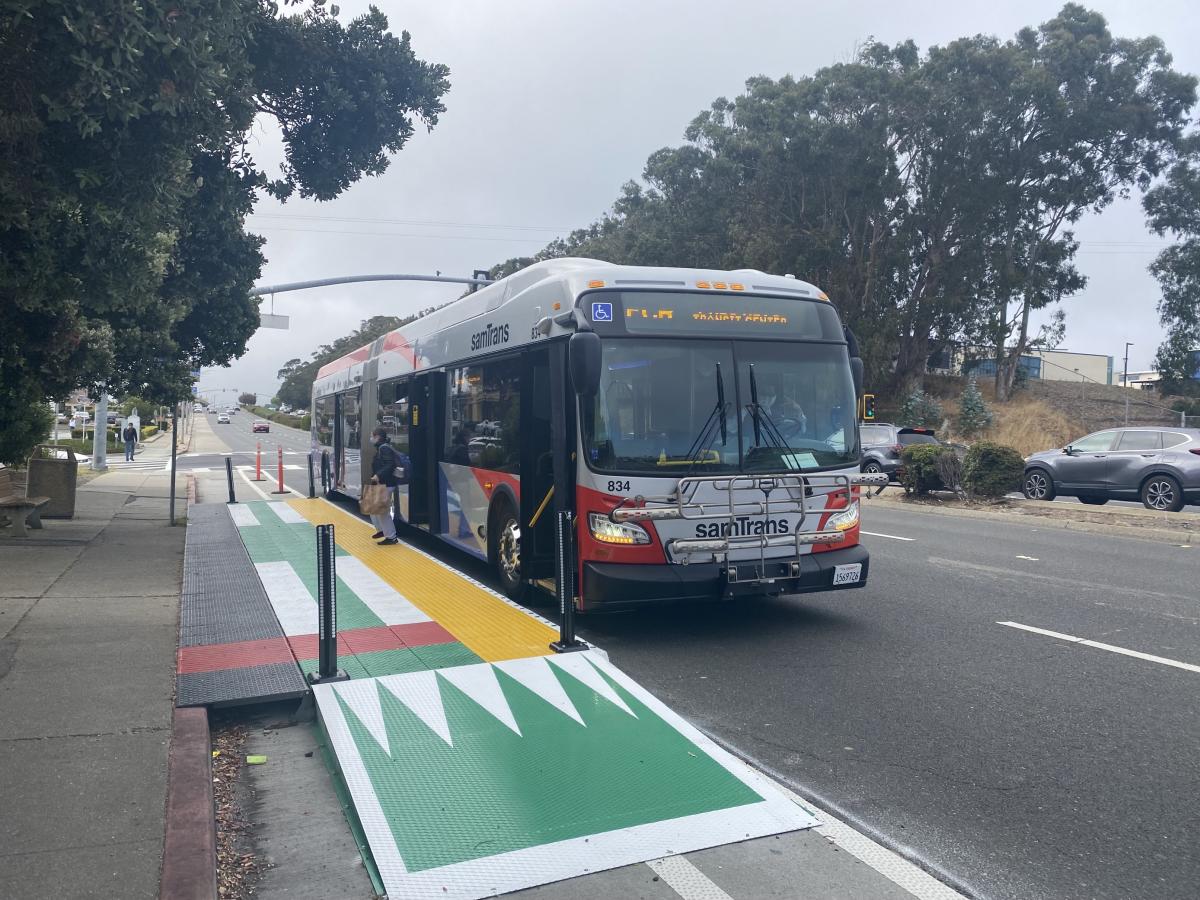 A bus pulls up to a temporary boarding platform on El Camino Real in South San Francisco.