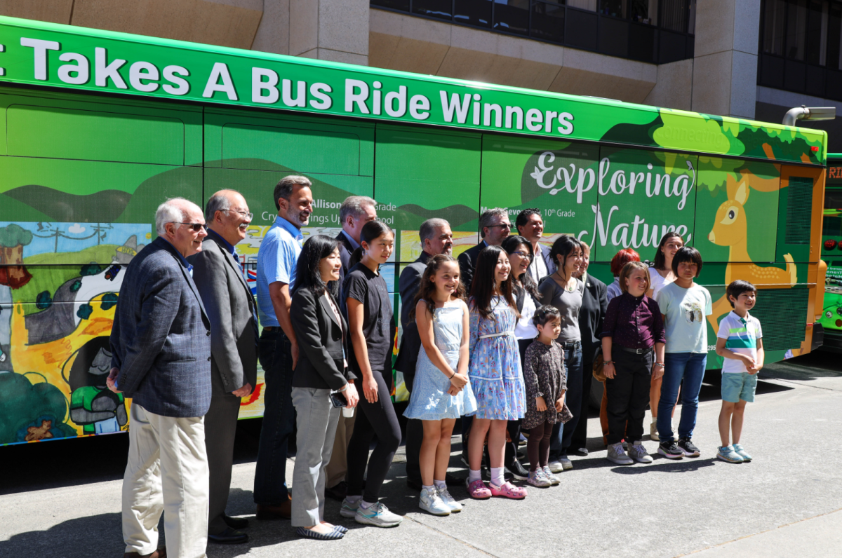 Art Takes a Bus Ride winners standing in front of bus.